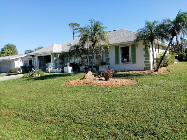 ranch-style house featuring a front yard and a garage