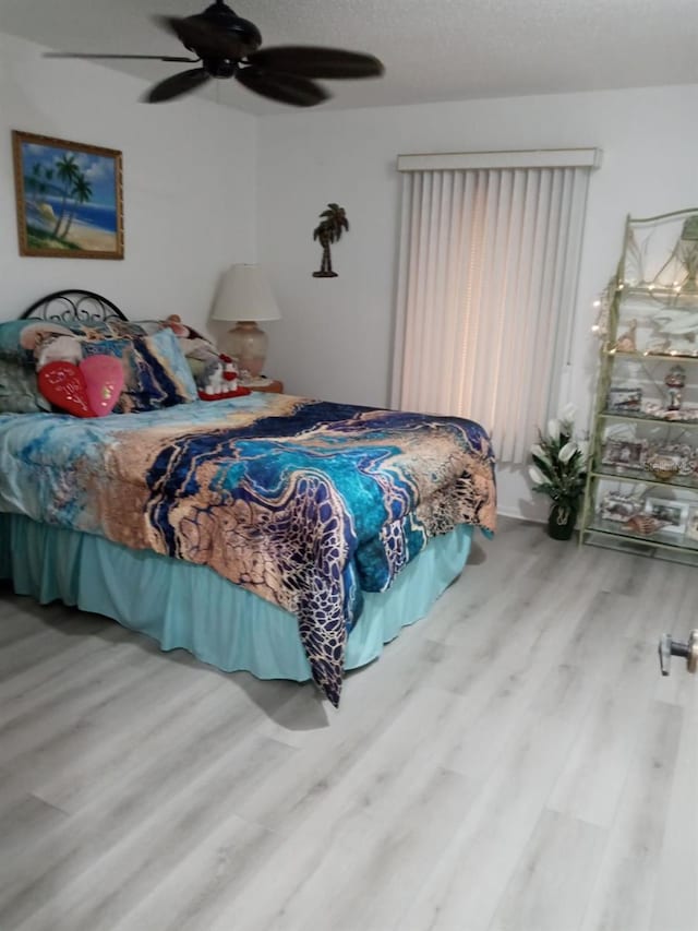 bedroom with hardwood / wood-style floors and ceiling fan