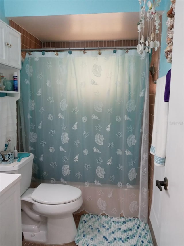 bathroom featuring walk in shower, tile patterned flooring, vanity, and toilet