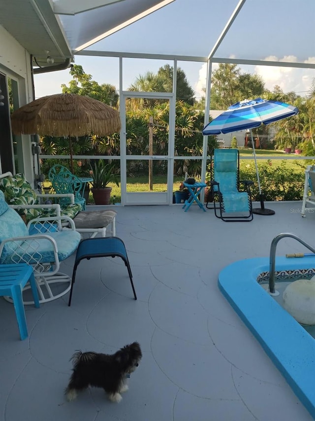 view of patio with glass enclosure