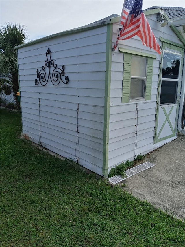 view of outbuilding featuring a lawn