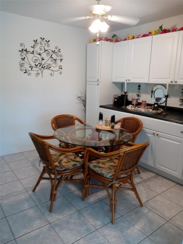 dining space with light tile patterned floors and ceiling fan