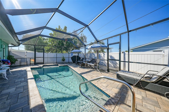 view of pool with a lanai and a patio area