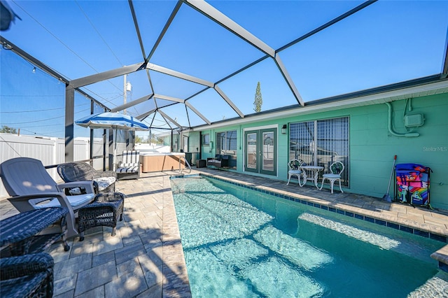 view of pool featuring french doors, a lanai, and a patio area