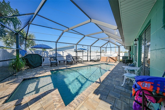 view of pool featuring a lanai, a patio area, and a hot tub