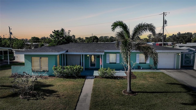 single story home with a yard and a garage