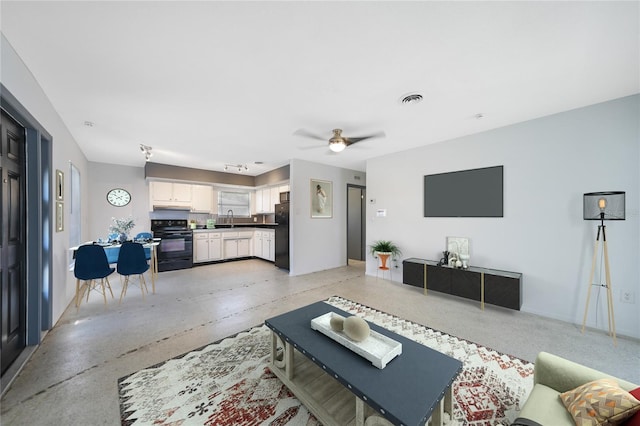 living room featuring ceiling fan and sink