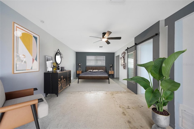 bedroom with a barn door and ceiling fan