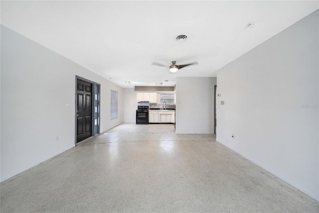 unfurnished living room with ceiling fan and sink