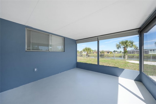 unfurnished sunroom with a water view