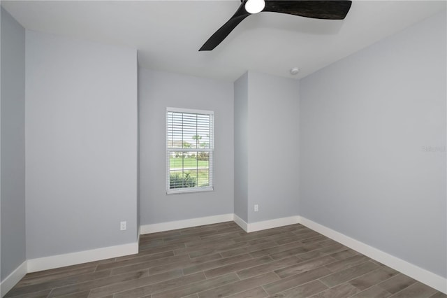 unfurnished room with ceiling fan and dark wood-type flooring