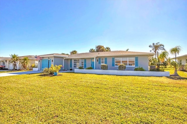 ranch-style house featuring a garage and a front lawn