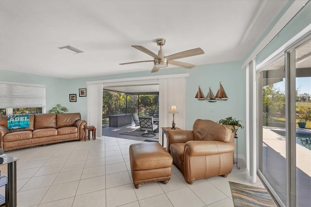 tiled living room with ceiling fan and a healthy amount of sunlight