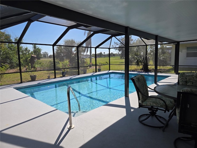 pool featuring glass enclosure and a patio area