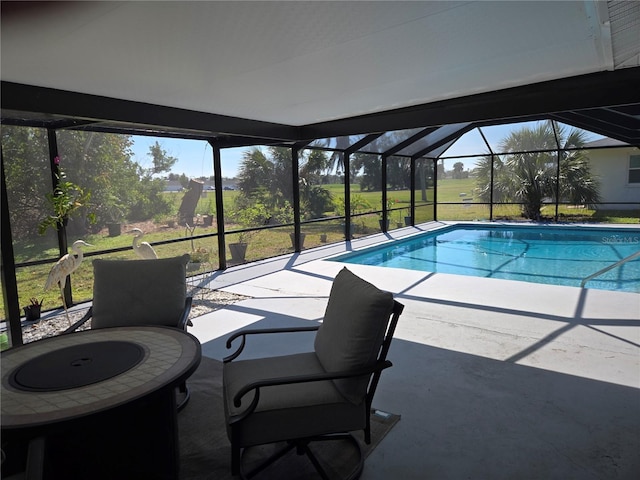 pool featuring glass enclosure and a patio