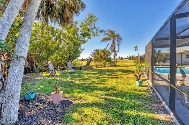 view of yard featuring a lanai and an outdoor pool