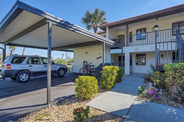 view of vehicle parking featuring a carport