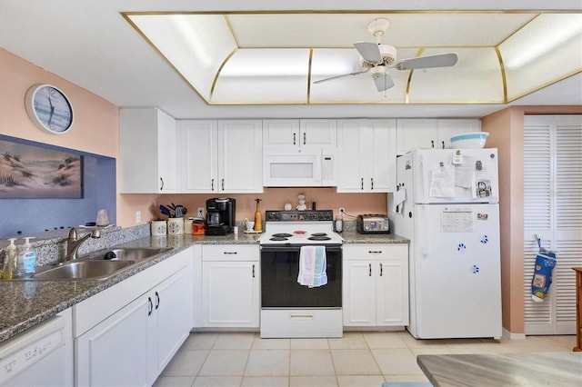 kitchen featuring white cabinetry, sink, light tile patterned floors, and white appliances