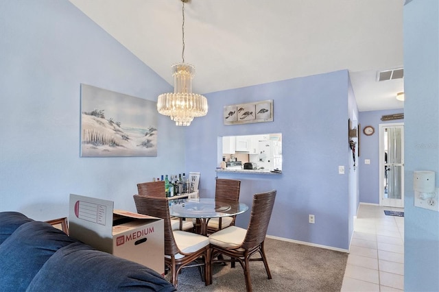 tiled dining space featuring an inviting chandelier and lofted ceiling