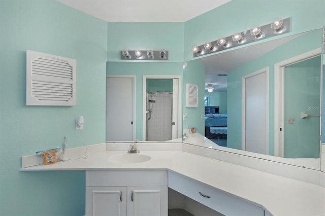 bathroom featuring vanity, ceiling fan, and a shower