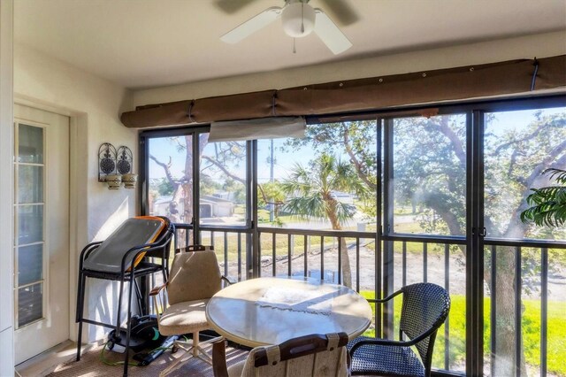 sunroom featuring ceiling fan and a wealth of natural light