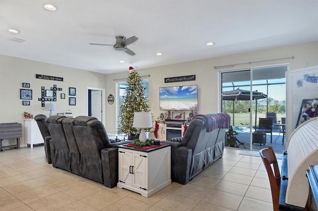 living room featuring ceiling fan and light tile patterned floors