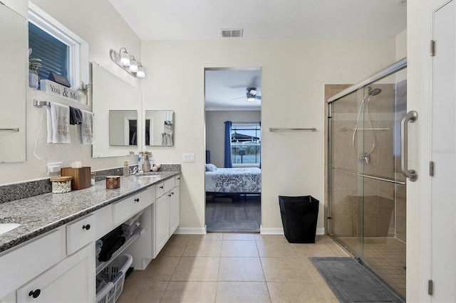 bathroom featuring ceiling fan, tile patterned flooring, vanity, and a shower with door