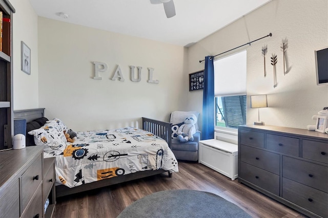 bedroom with dark hardwood / wood-style flooring and ceiling fan