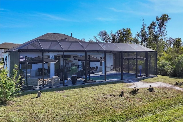 view of home's community featuring a lawn, a patio area, and a pool