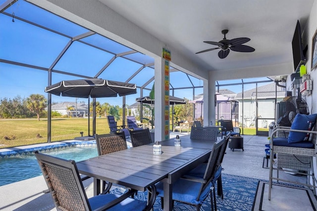 view of patio featuring a ceiling fan, glass enclosure, outdoor dining space, and an outdoor pool