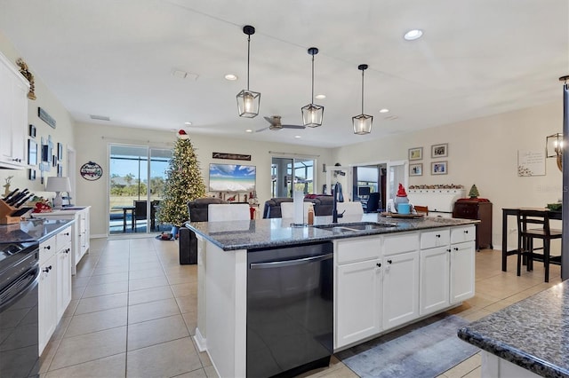 kitchen with open floor plan, dishwashing machine, a center island with sink, recessed lighting, and a sink