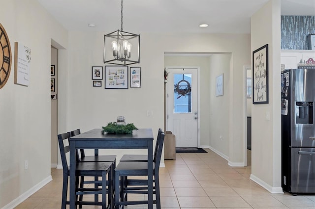 dining area with recessed lighting, baseboards, an inviting chandelier, and light tile patterned floors