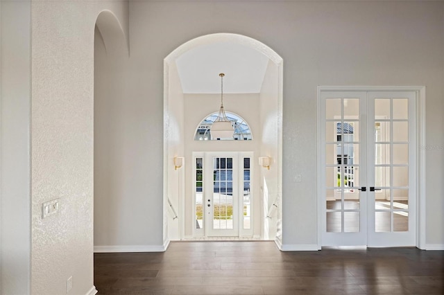 entryway featuring dark wood-type flooring and french doors