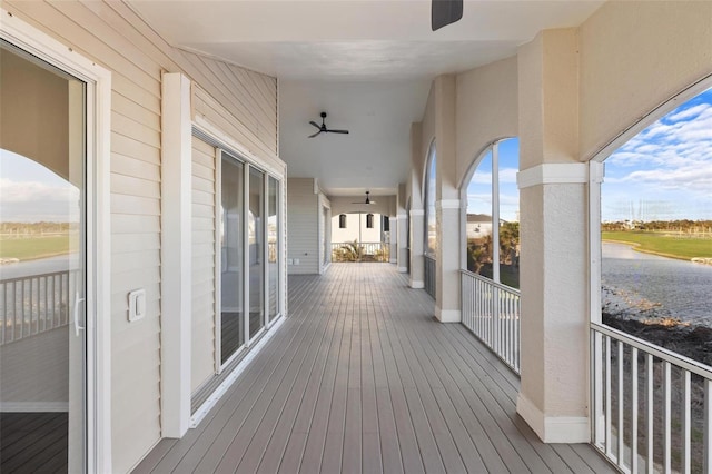 wooden deck featuring ceiling fan