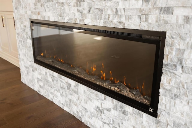 room details featuring a fireplace and wood-type flooring