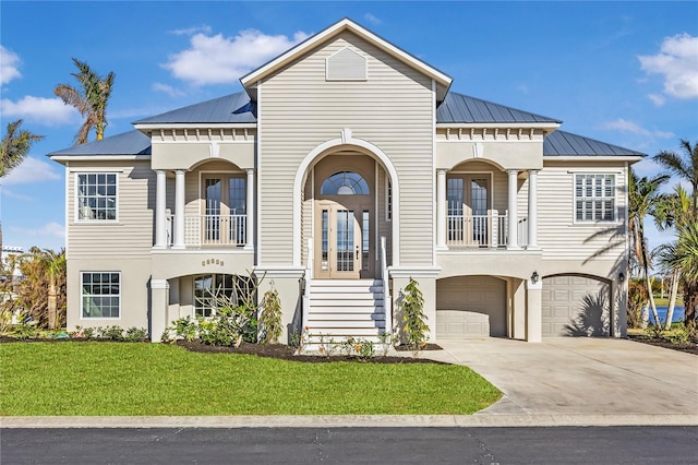 view of front of property featuring a front yard and a garage