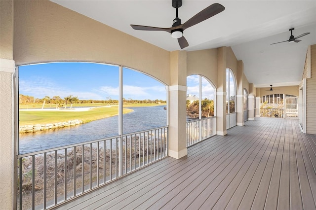 deck featuring a water view and ceiling fan