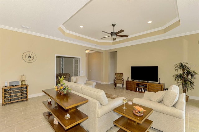 living room featuring a tray ceiling and ornamental molding