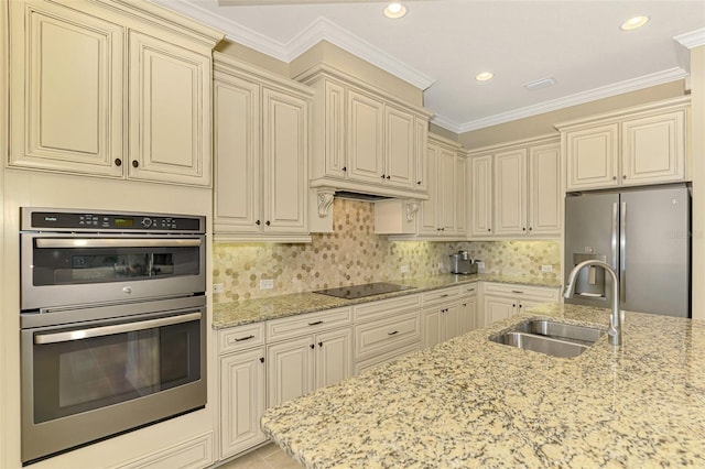 kitchen featuring crown molding, sink, stainless steel appliances, and cream cabinets