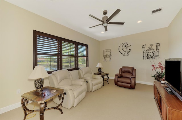 living room with ceiling fan and light carpet