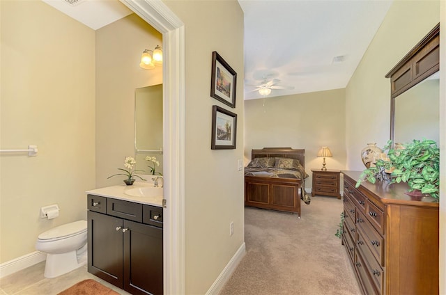 bathroom featuring ceiling fan, vanity, and toilet