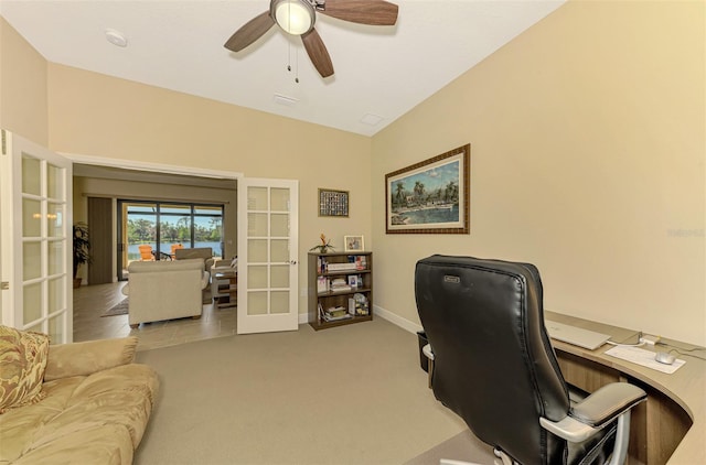 carpeted office space with french doors, vaulted ceiling, and ceiling fan