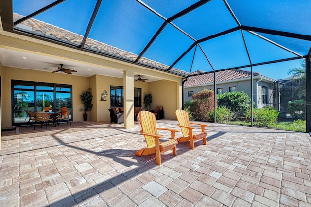 view of patio with ceiling fan and a lanai