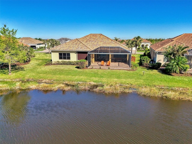 back of house with a yard, a water view, a patio, and a lanai