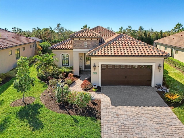 mediterranean / spanish-style house with a front yard and a garage