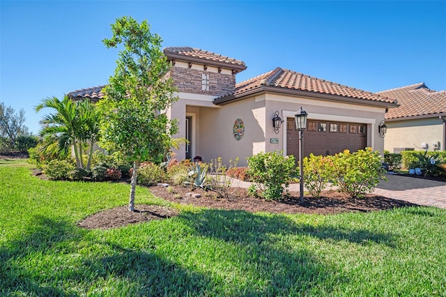 mediterranean / spanish-style home featuring a garage and a front lawn