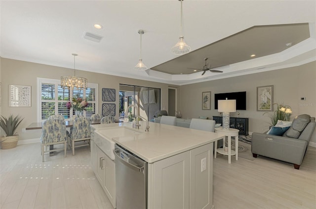 kitchen featuring white cabinetry, dishwasher, sink, an island with sink, and ceiling fan with notable chandelier