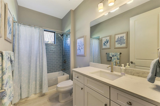 full bathroom featuring shower / bath combo with shower curtain, hardwood / wood-style floors, vanity, and toilet