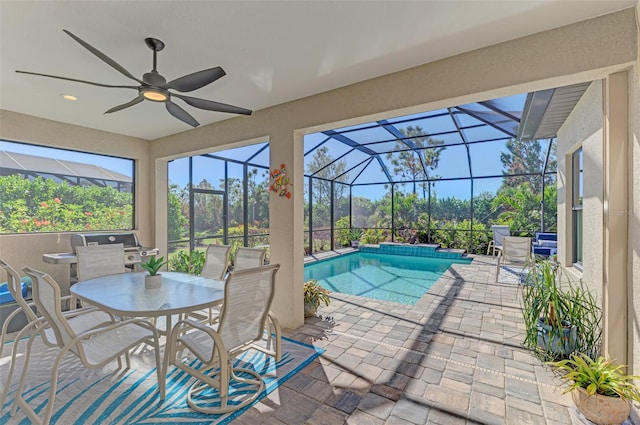 view of pool with a lanai, ceiling fan, and a patio area