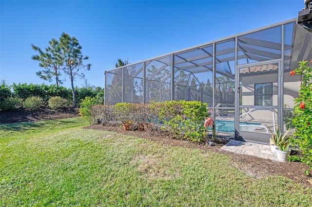 view of yard with glass enclosure